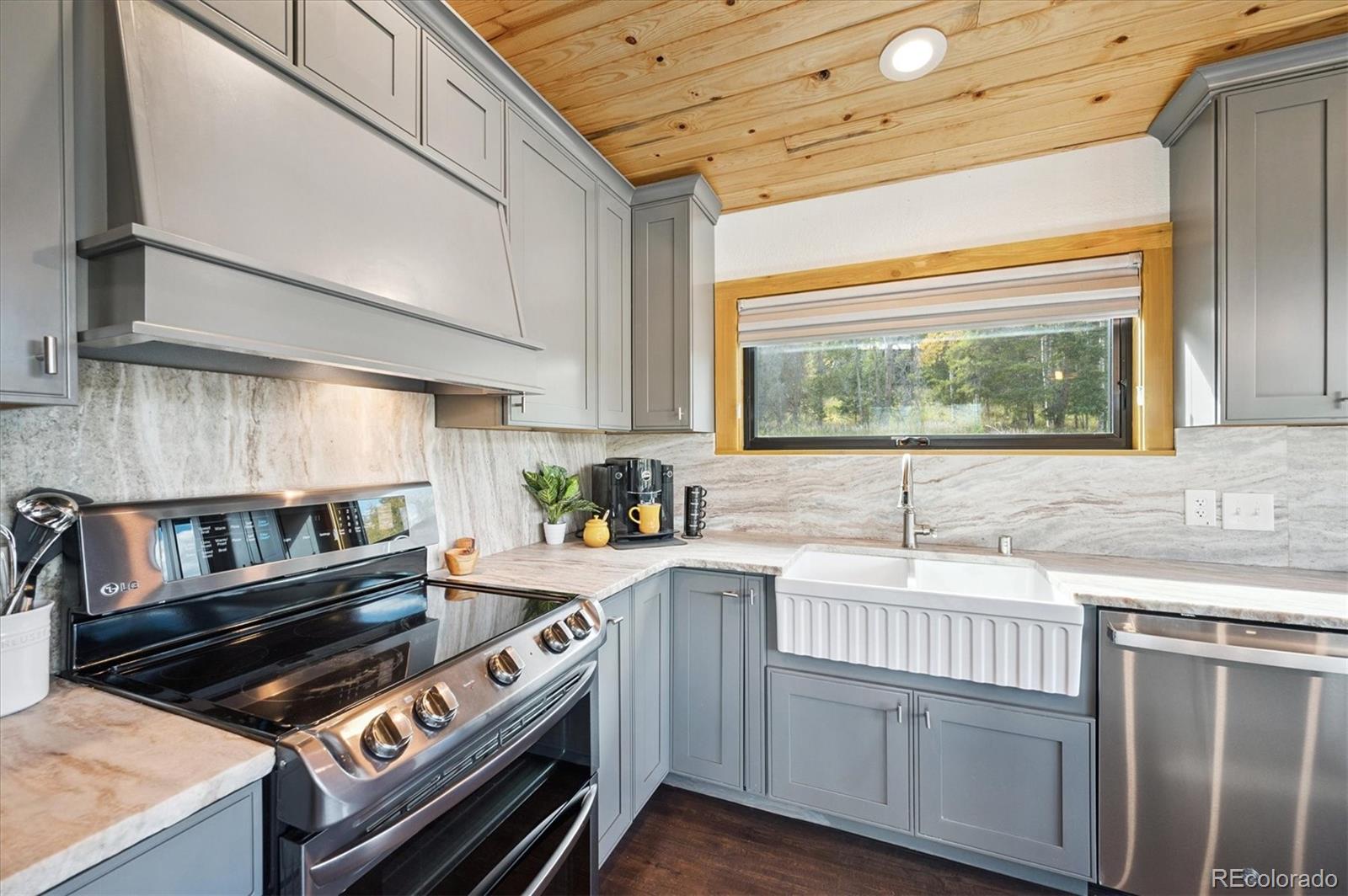 12369 Quartz Spur Conifer, CO 80433 - Photo 10 of 36 a kitchen with a stove a sink and a microwave