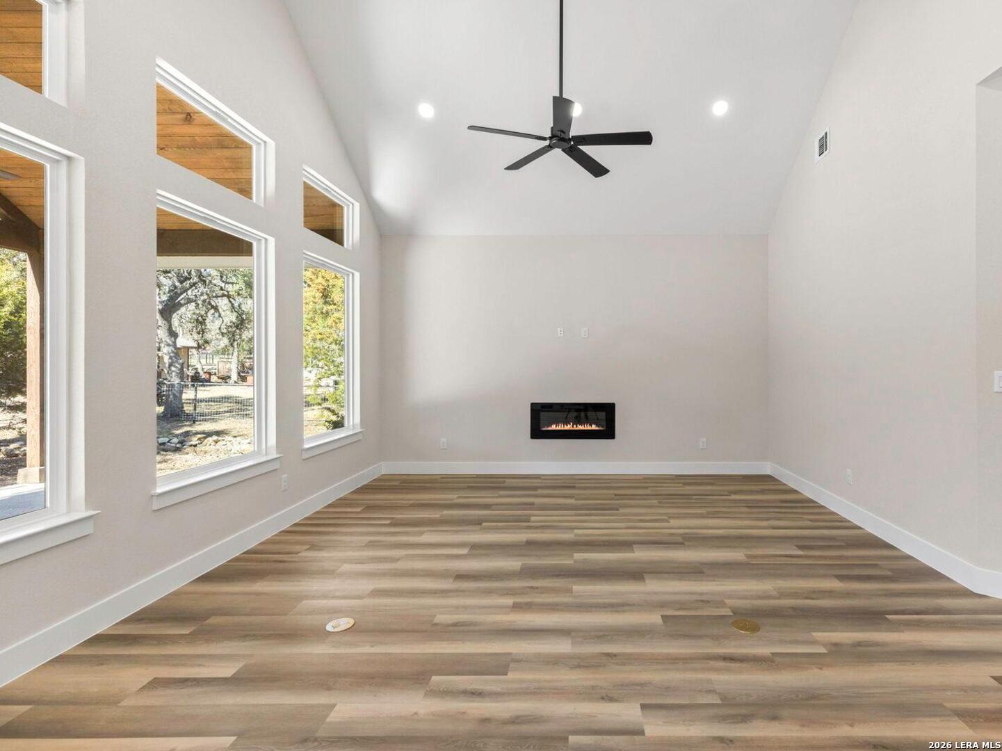 1270 Misty Lane Spring Branch, TX 78070 - Photo 11 of 48 a view of an empty room with a window and wooden floor