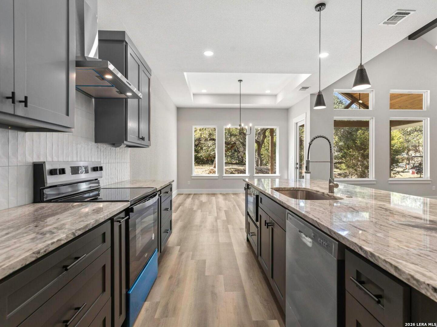 1270 Misty Lane Spring Branch, TX 78070 - Photo 15 of 48 a kitchen with granite countertop a sink and a stove