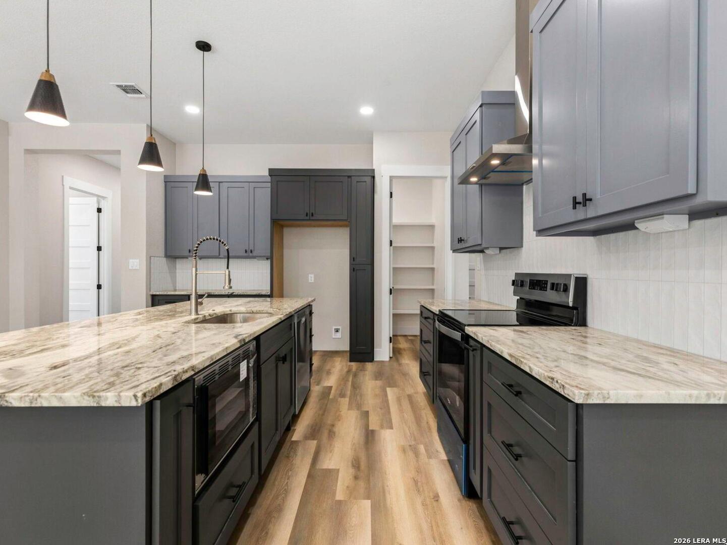 1270 Misty Lane Spring Branch, TX 78070 - Photo 16 of 48 a kitchen with granite countertop a sink a counter top space stainless steel appliances and cabinets