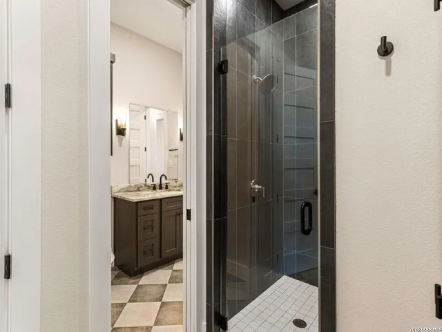 a bathroom with a shower and a sink