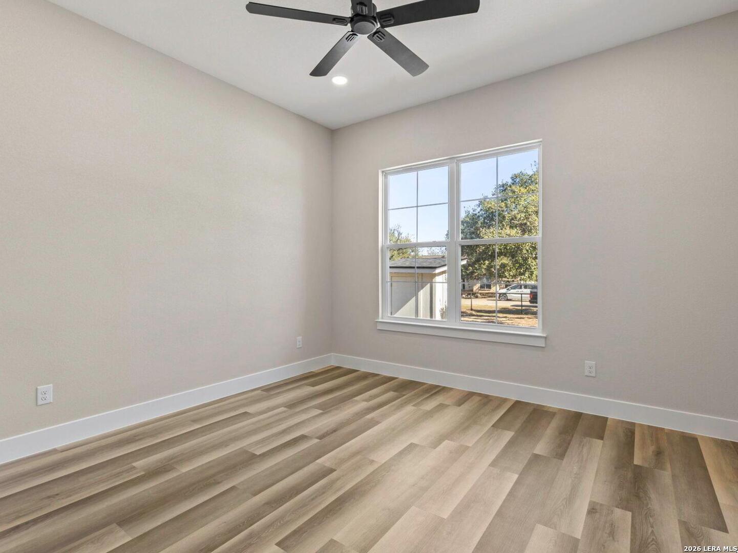 1270 Misty Lane Spring Branch, TX 78070 - Photo 20 of 48 wooden floor in an empty room with a window