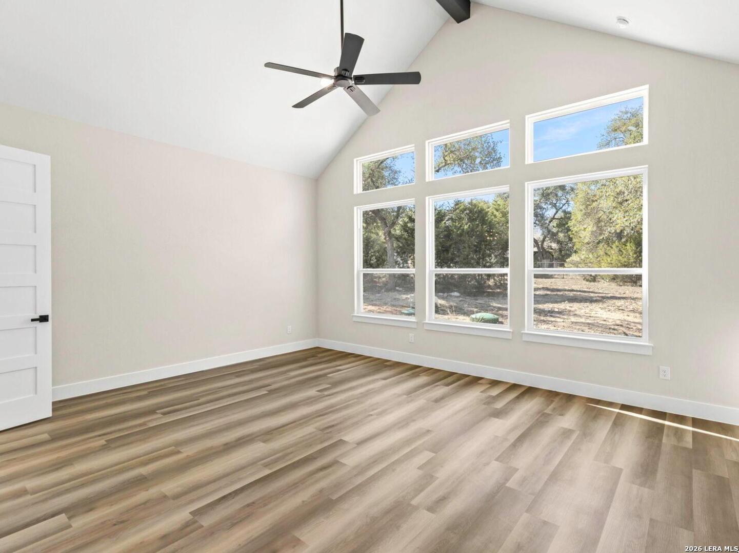 1270 Misty Lane Spring Branch, TX 78070 - Photo 23 of 48 a view of an empty room with wooden floor and a window