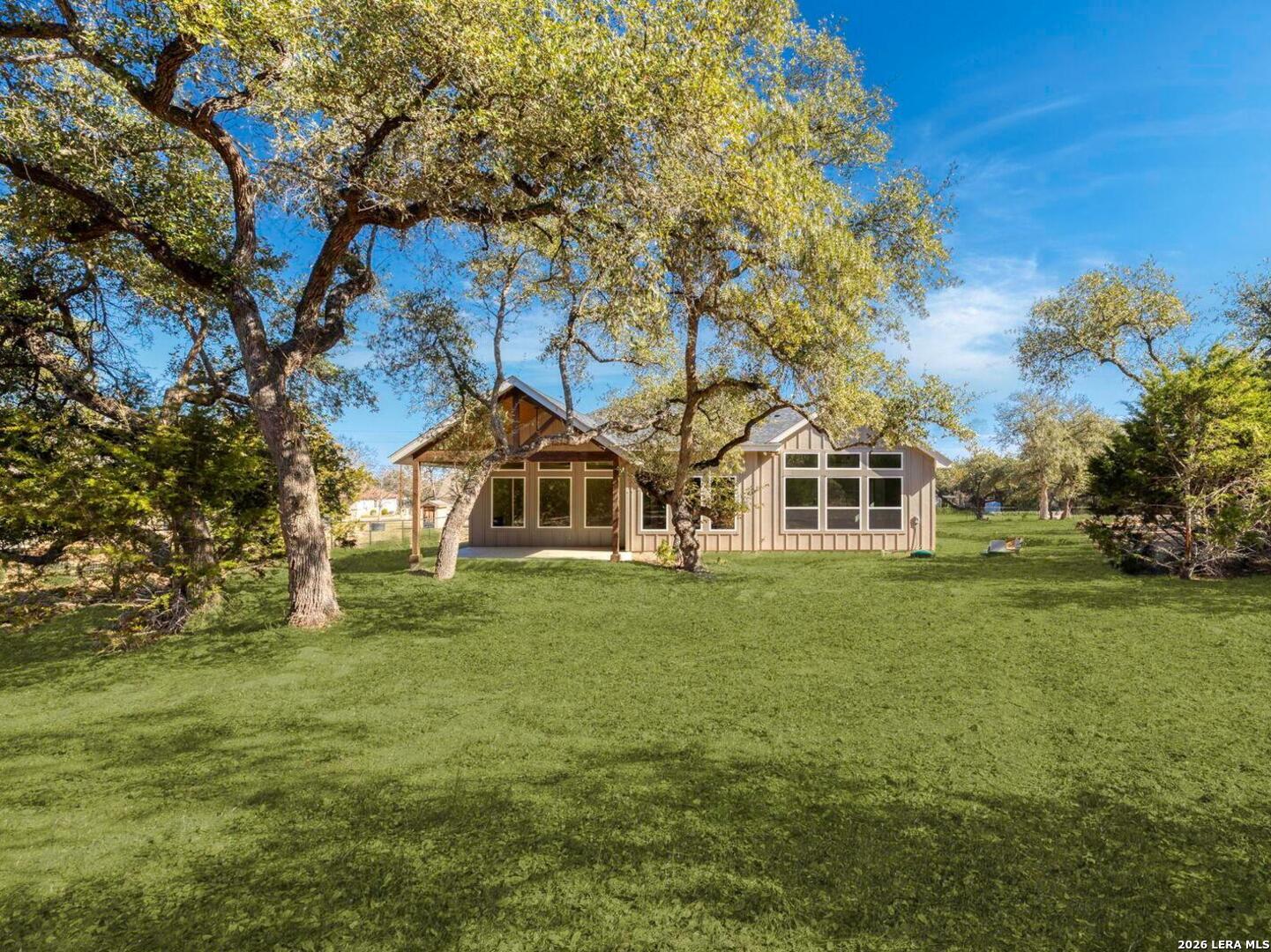 1270 Misty Lane Spring Branch, TX 78070 - Photo 35 of 48 a front view of a house with a garden