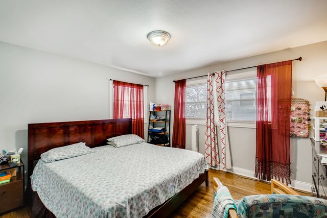 a bed sitting in a bedroom next to a window