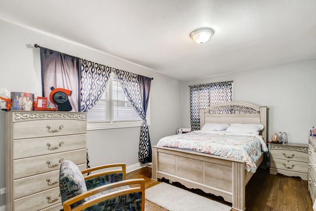 a bedroom with a bed and a dresser