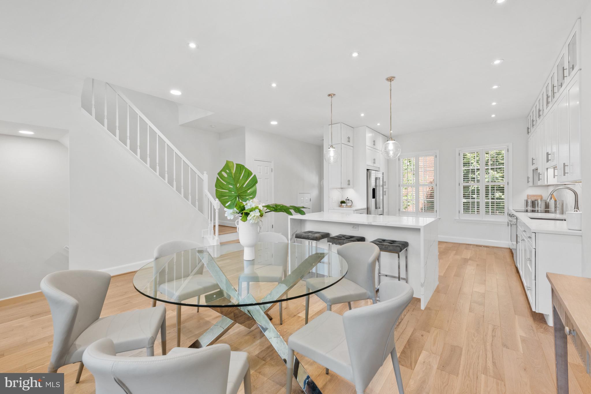 3604 Winfield Lane Northwest Washington, DC 20007 - Photo 7 of 35 a kitchen with kitchen island granite countertop a table and chairs in it