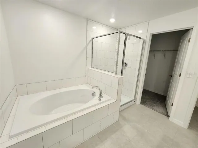 a bathroom with a bathtub and a shower