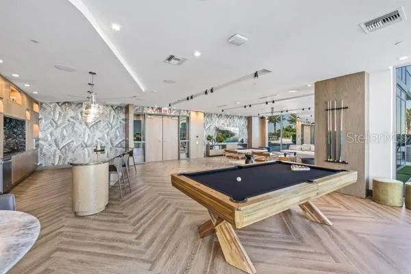 a living room with a table tennis table and a large window