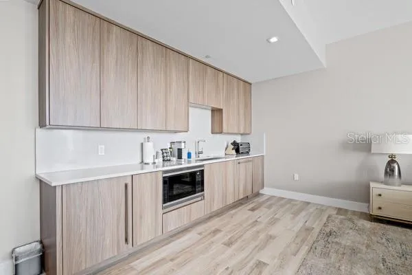 a kitchen with granite countertop a sink and cabinets