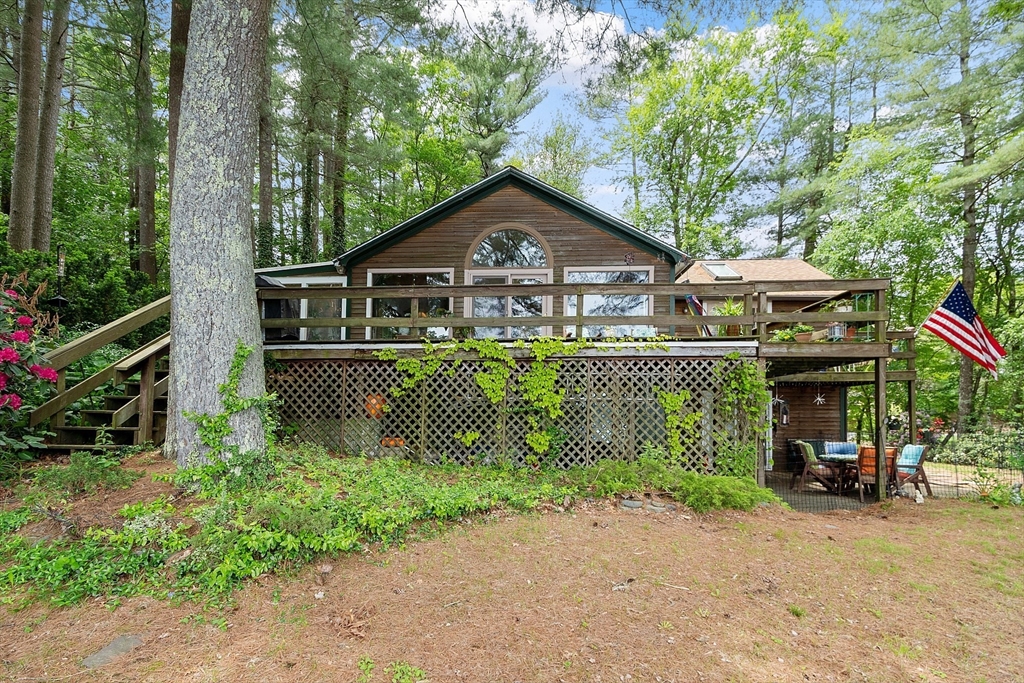 151 Flynn Road Lunenburg, MA 01462 - Photo 12 of 41 a front view of a house with a garden and trees