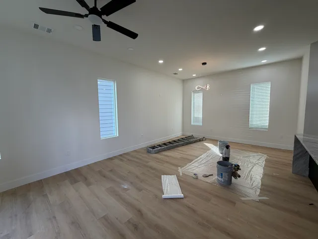 a kitchen with a refrigerator a sink and wooden cabinets