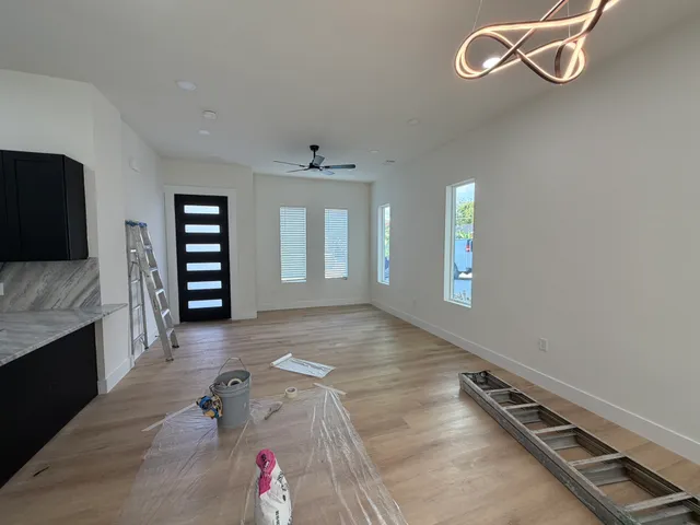 a large kitchen with kitchen island a sink stainless steel appliances and cabinets