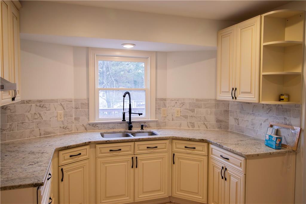 1292 Monfort Road Lawrenceville, GA 30046 - Photo 6 of 48 a view of a sink dishwasher and cabinets with wooden floor