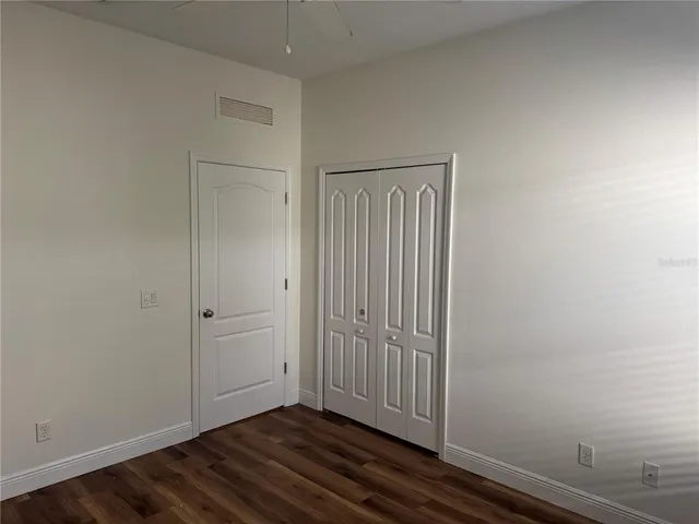 an empty room with wooden floor