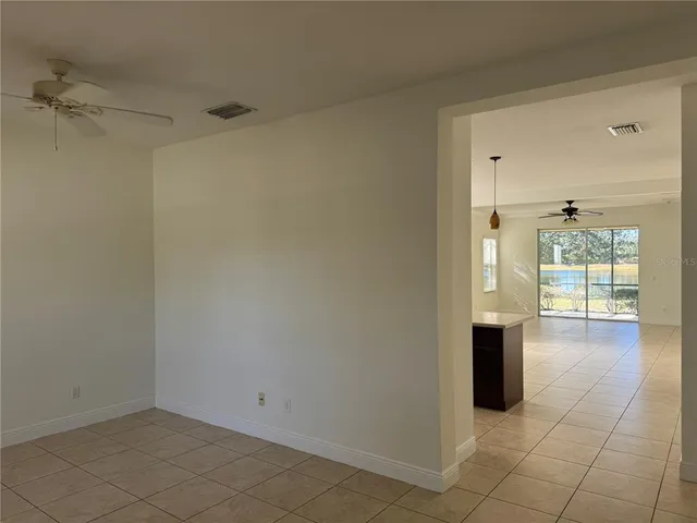 a view of empty room with wooden floor and cabinet