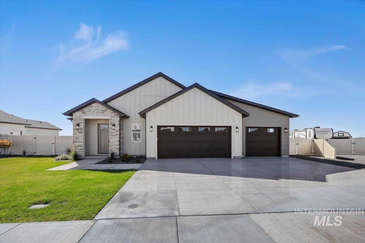 563 Moonstone Road Kimberly, ID 83341 - Photo 3 of 48 Contemporary exterior with board and batten siding, stone accents, a covered entry, and a three-car front-facing garage