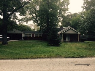 3911 Merioneth Drive Crete, IL 60417 - Photo 1 of 19 a front view of a house with a garden and trees