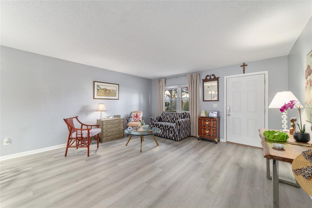 9951 Southwest 88th Court Road, Unit G Ocala, FL 34481 - Photo 11 of 59 a living room with furniture and wooden floor