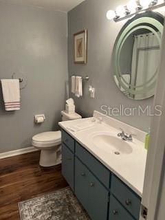9951 Southwest 88th Court Road, Unit G Ocala, FL 34481 - Photo 16 of 38 a bathroom with a toilet a sink and mirror