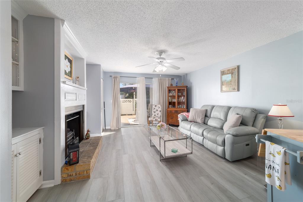 9951 Southwest 88th Court Road, Unit G Ocala, FL 34481 - Photo 21 of 59 a living room with furniture and a fireplace