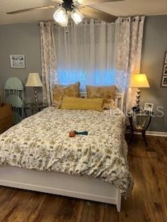 9951 Southwest 88th Court Road, Unit G Ocala, FL 34481 - Photo 21 of 38 a bed sitting in a bedroom next to a lamp