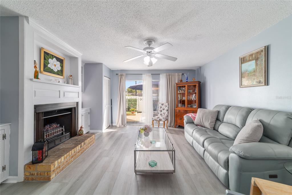 9951 Southwest 88th Court Road, Unit G Ocala, FL 34481 - Photo 23 of 59 a living room with furniture and a fireplace