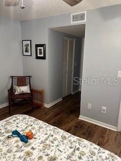 9951 Southwest 88th Court Road, Unit G Ocala, FL 34481 - Photo 23 of 38 a bedroom with a bed and wooden floor