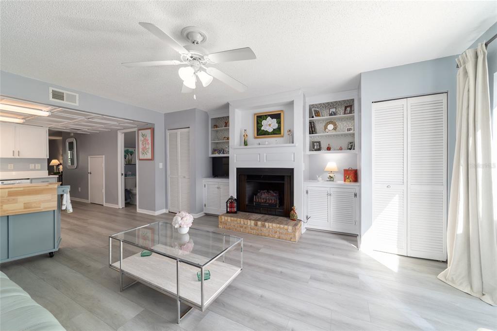 9951 Southwest 88th Court Road, Unit G Ocala, FL 34481 - Photo 26 of 59 a living room with furniture and a fireplace