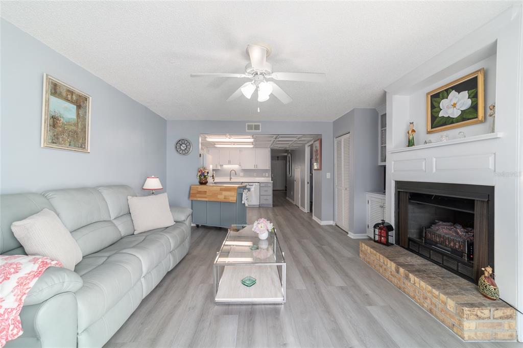 9951 Southwest 88th Court Road, Unit G Ocala, FL 34481 - Photo 27 of 59 a living room with furniture and a fireplace
