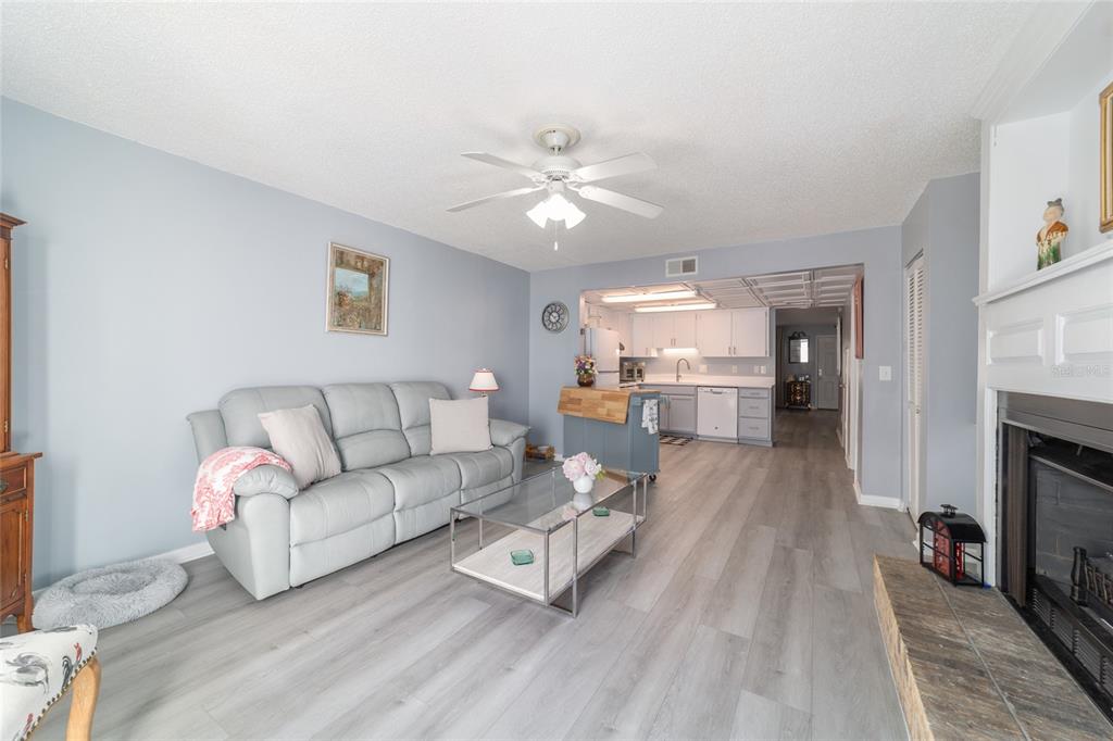 9951 Southwest 88th Court Road, Unit G Ocala, FL 34481 - Photo 28 of 59 a living room with furniture and a fireplace