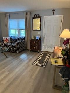 9951 Southwest 88th Court Road, Unit G Ocala, FL 34481 - Photo 3 of 38 a room with furniture and a flat screen tv