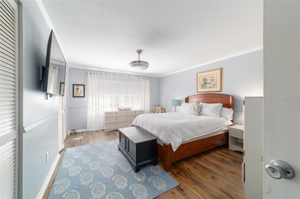 9951 Southwest 88th Court Road, Unit G Ocala, FL 34481 - Photo 33 of 59 a spacious bedroom with a bed and a couch