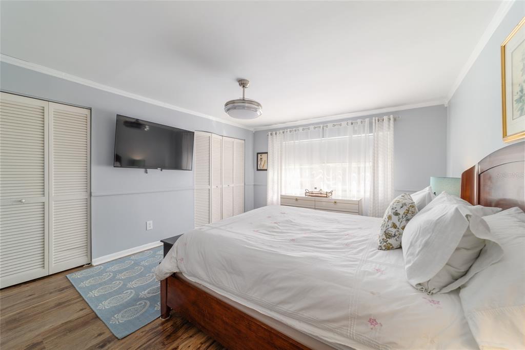 9951 Southwest 88th Court Road, Unit G Ocala, FL 34481 - Photo 34 of 59 a bedroom with a bed and a flat screen tv