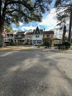 9951 Southwest 88th Court Road, Unit G Ocala, FL 34481 - Photo 35 of 38 a view of a big house next to a road