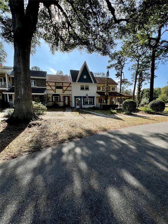 9951 Southwest 88th Court Road, Unit G Ocala, FL 34481 - Photo 36 of 38 a view of a house with a yard