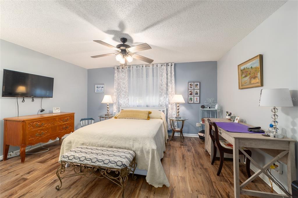 9951 Southwest 88th Court Road, Unit G Ocala, FL 34481 - Photo 40 of 59 a bedroom with a bed and a table in it