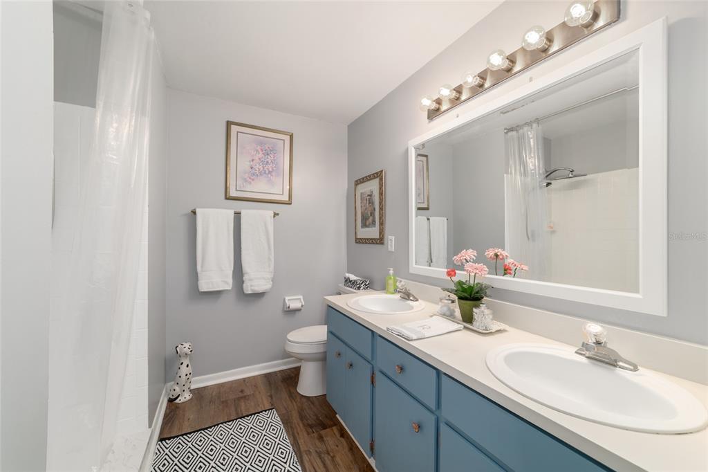 9951 Southwest 88th Court Road, Unit G Ocala, FL 34481 - Photo 45 of 59 a bathroom with a double vanity sink mirror and toilet