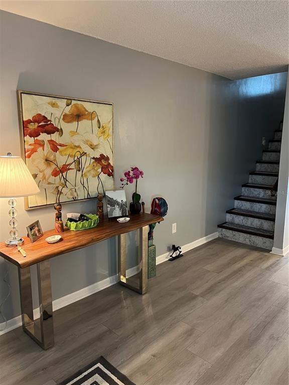 9951 Southwest 88th Court Road, Unit G Ocala, FL 34481 - Photo 5 of 38 a room with wooden floor and shoes