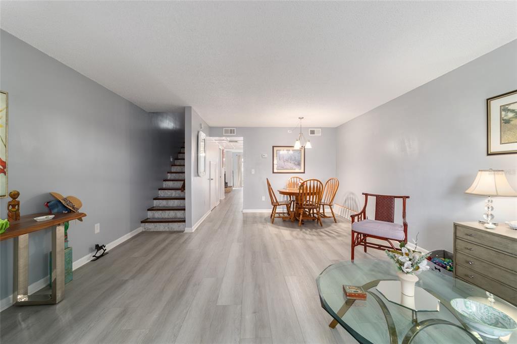 9951 Southwest 88th Court Road, Unit G Ocala, FL 34481 - Photo 5 of 59 a living room with furniture and wooden floor