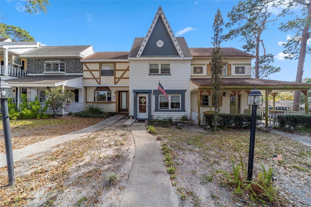 9951 Southwest 88th Court Road, Unit G Ocala, FL 34481 - Photo 55 of 59 a front view of a house with a garden