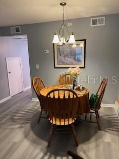 9951 Southwest 88th Court Road, Unit G Ocala, FL 34481 - Photo 7 of 38 a view of a dining room with furniture a chandelier and wooden floor