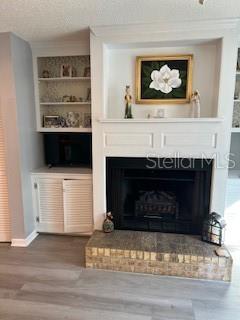 9951 Southwest 88th Court Road, Unit G Ocala, FL 34481 - Photo 8 of 38 a living room with a fireplace and a stove