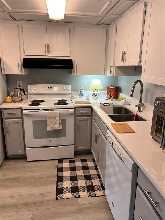 9951 Southwest 88th Court Road, Unit G Ocala, FL 34481 - Photo 10 of 38 a kitchen with a sink a stove and cabinets