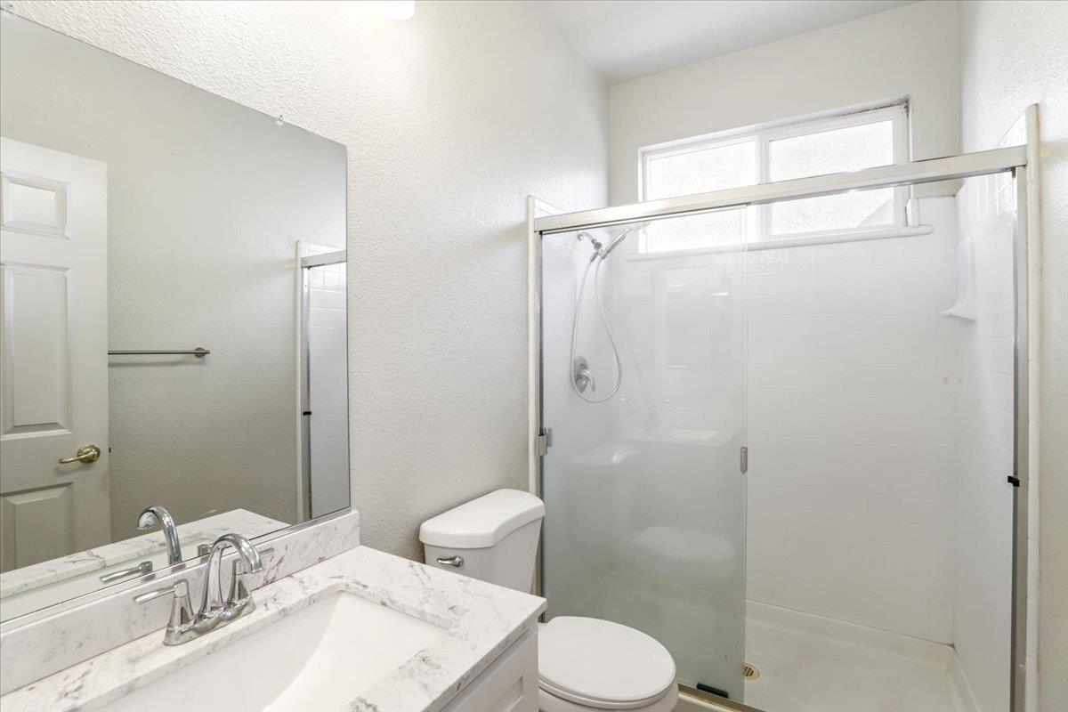 4467 Glenbrook Drive Tracy, CA 95377 - Photo 11 of 26 a bathroom with a sink toilet and shower