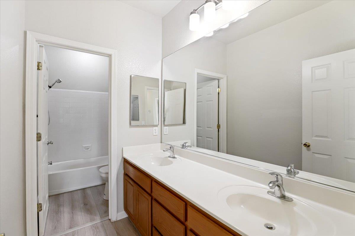 4467 Glenbrook Drive Tracy, CA 95377 - Photo 15 of 26 a bathroom with a double vanity sink mirror and shower