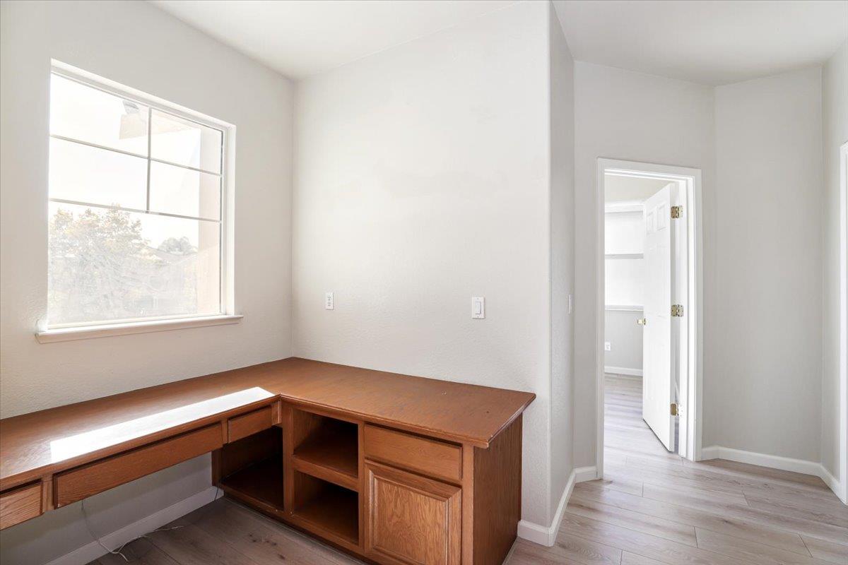 4467 Glenbrook Drive Tracy, CA 95377 - Photo 16 of 26 an empty room with wooden floor and windows