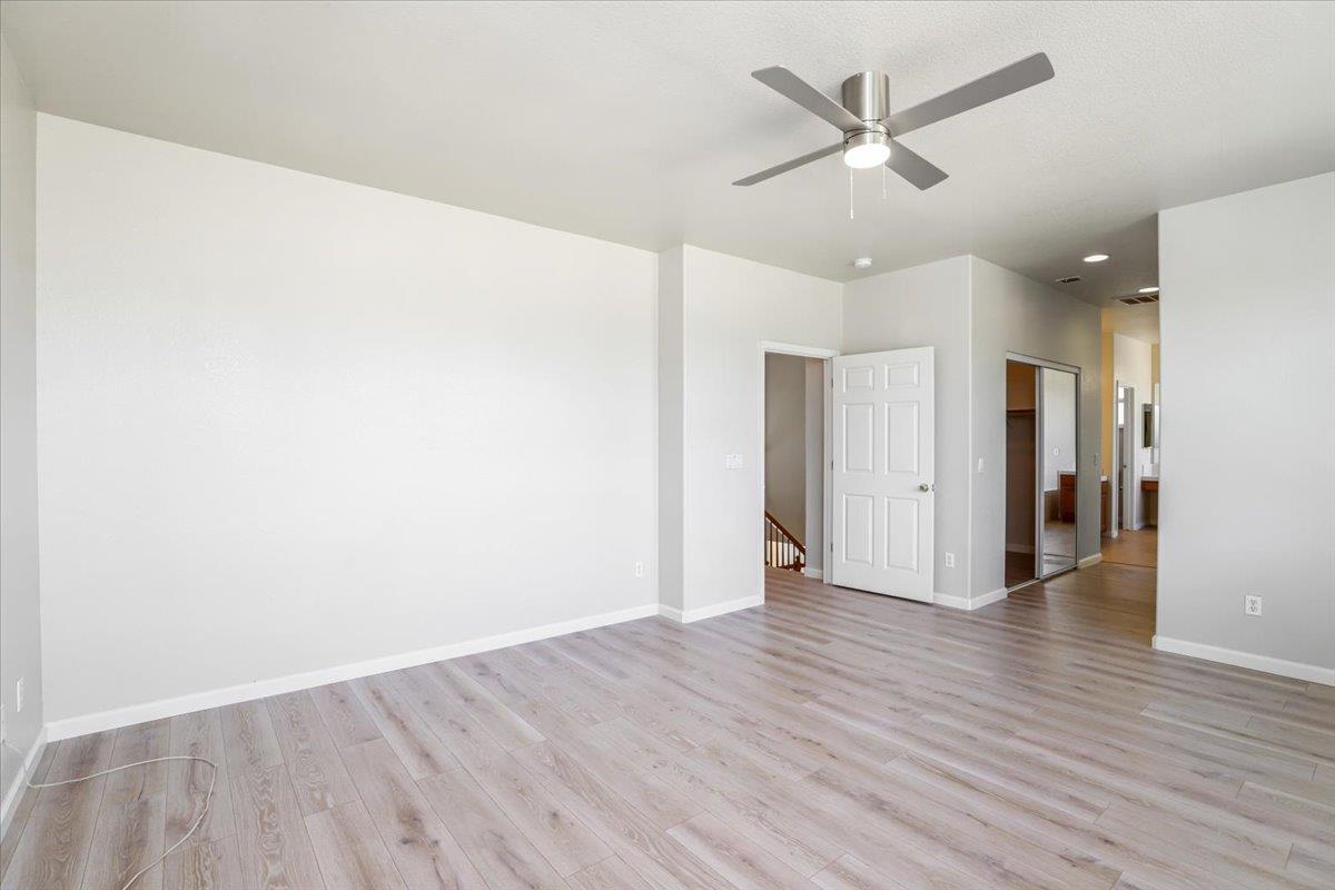4467 Glenbrook Drive Tracy, CA 95377 - Photo 20 of 26 an empty room with wooden floor and a ceiling fan