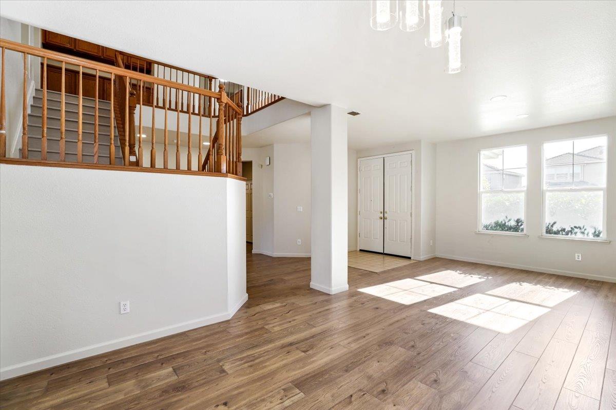 4467 Glenbrook Drive Tracy, CA 95377 - Photo 7 of 26 wooden floor in an empty room with windows