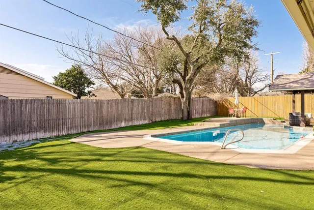 a view of a swimming pool with a patio
